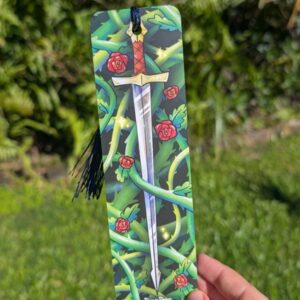 A bookmark of a sword wraped in rose vines. A tassel hangs from a hole punch in the hilt of the sword.