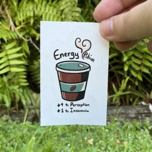 Text on sticker reads: Energy potion, +4 to perception, +1 to insominia. Coffie cup with steam.